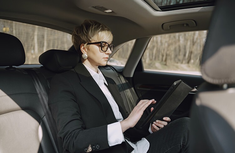 A business woman getting chauffeured by our team